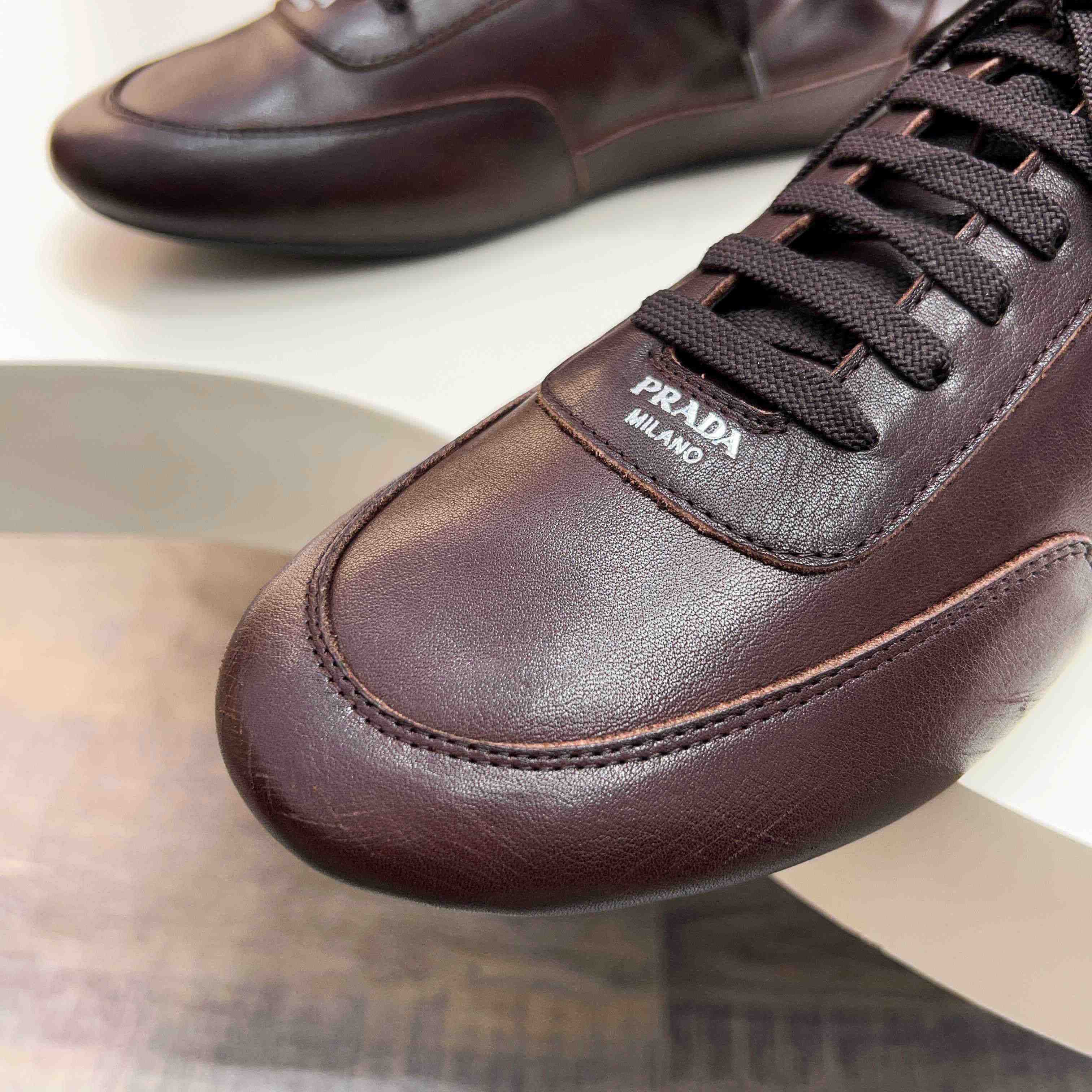 Prada Collapse Leather Sneakers - DesignerGu